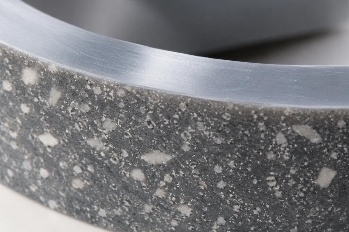 Close-up of polymer bearing surface texture showing filler distribution and smooth finish