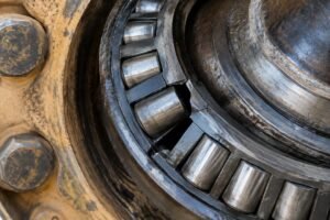 Close-up view of a tapered roller bearing cage fracture in a mining truck wheel hub